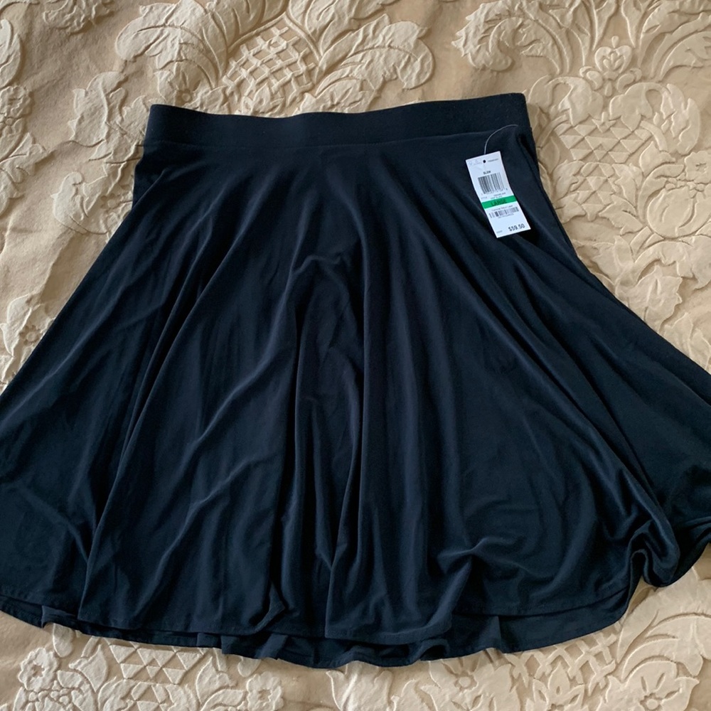 Large black skirt made by INC international, 95% polyester, 5% spandex.  New.
